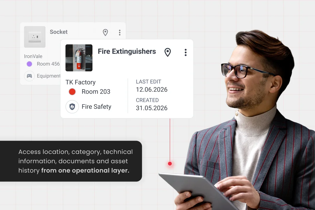 Smiling man in glasses holding a tablet beside SIM-ON asset cards for Socket and Fire Extinguishers (TK Factory, Room 203, Fire Safety, last edit and created dates), with a note about accessing location, category, documents and asset history from one operational layer.