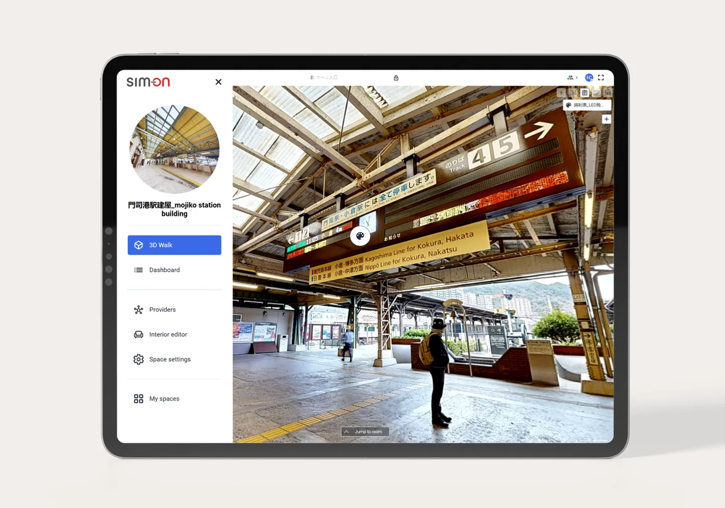 Tablet showing SIM-ON 3D Walk of the Mojiko Station building: a platform under signs for tracks 4–5 and the Kagoshima Line to Kokura and Hakata
