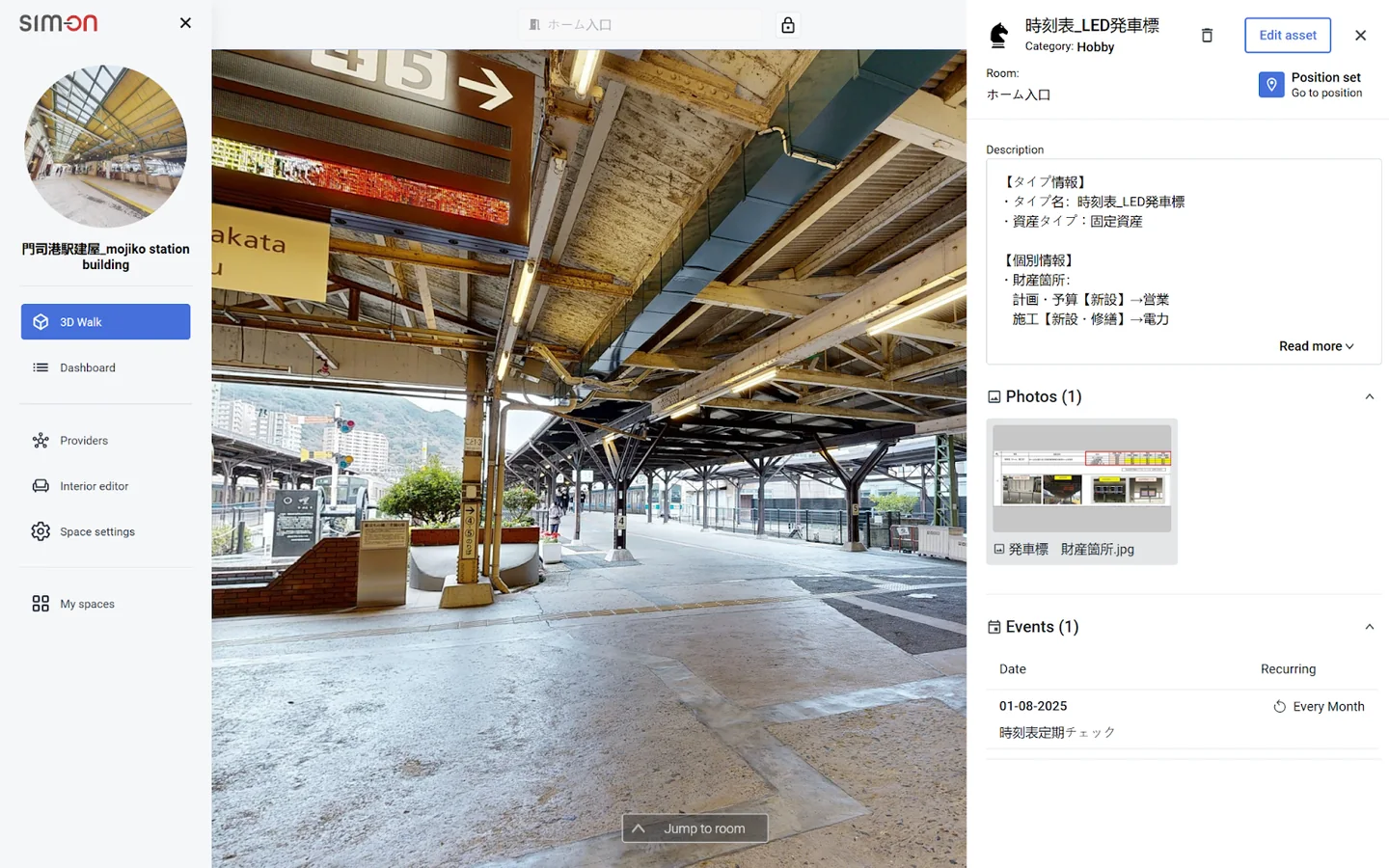 SIM-ON view of a Mojiko Station platform with an open asset panel for an LED departure board, showing its description, a photo and a monthly recurring check