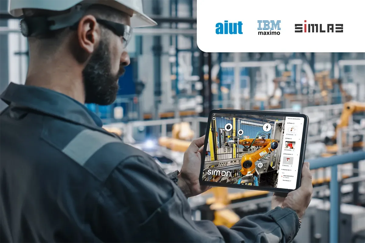 Engineer in a hard hat holding a tablet with a SIM-ON 3D view of an orange industrial robot; Aiut, IBM Maximo and SIMLAB logos