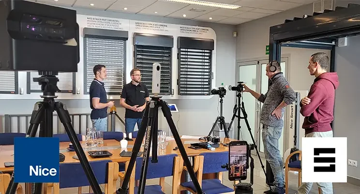 Video shoot in the Nice showroom: SIMLAB and Nice staff standing by roller blind samples, surrounded by cameras, tripods and a Matterport scanner, with Nice and SIMLAB logos