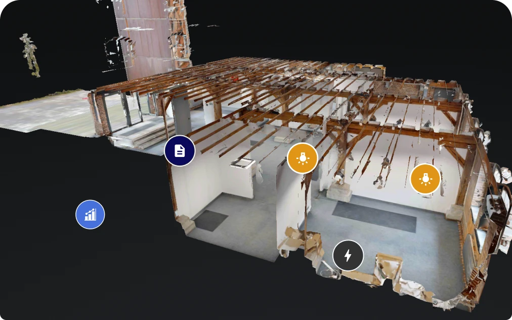 3D dollhouse model of a gutted building interior with exposed roof beams and round asset markers