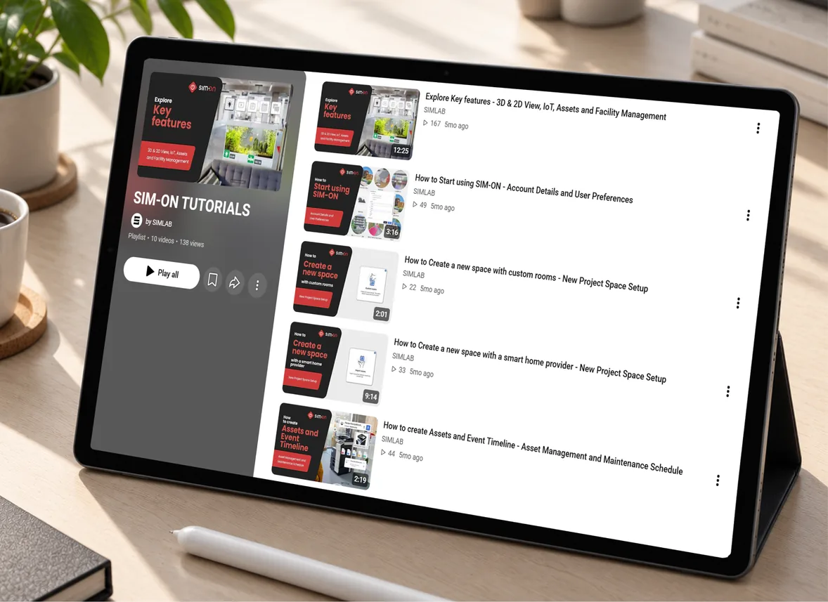 A tablet on a desk showing the SIM-ON TUTORIALS playlist by SIMLAB, with videos on key features, getting started, creating a new space and setting up asset and event timelines.